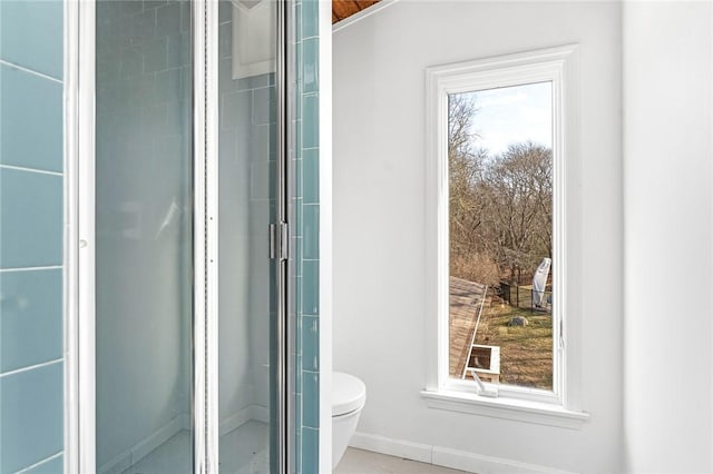 full bath with a shower with door, toilet, and baseboards