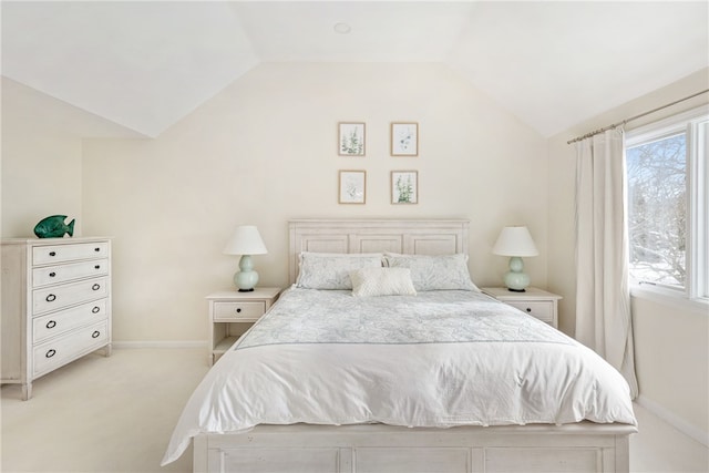 bedroom featuring vaulted ceiling, multiple windows, and light carpet