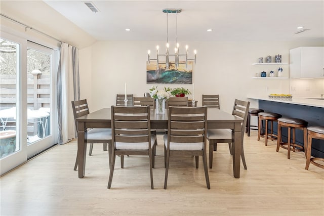 dining space featuring a notable chandelier, visible vents, light wood-style flooring, and recessed lighting