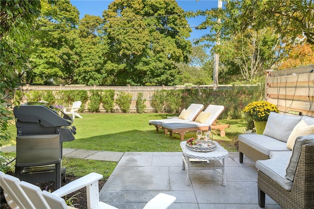 view of patio with an outdoor hangout area, area for grilling, and a fenced backyard