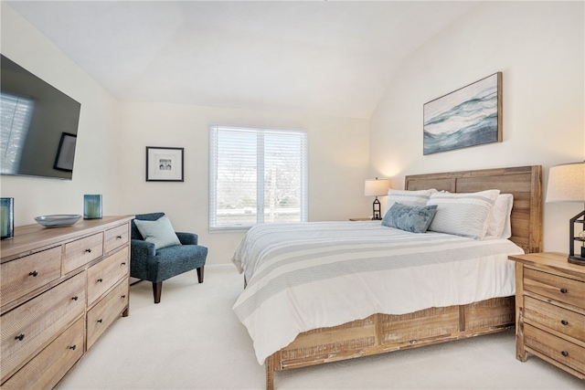 bedroom featuring vaulted ceiling and light carpet