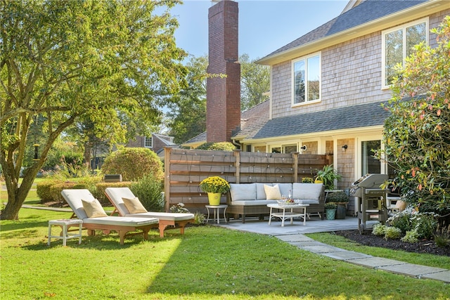 view of yard featuring a patio area, outdoor lounge area, and fence