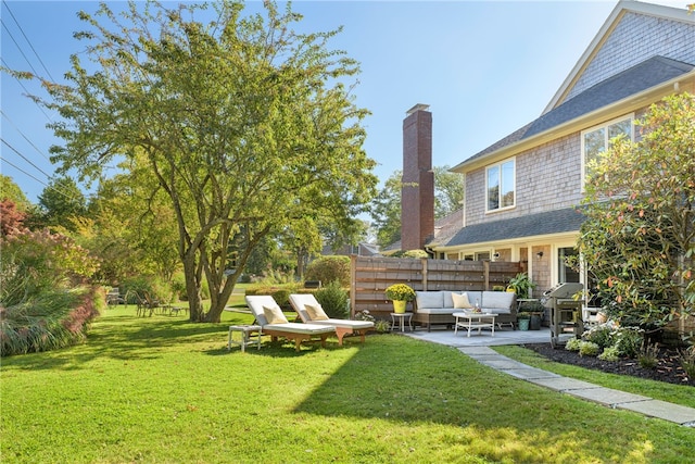 view of yard featuring outdoor lounge area, a patio, and fence