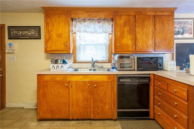 kitchen with dishwasher, light countertops, brown cabinetry, and a sink