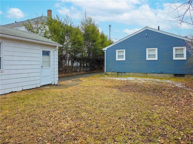 view of property exterior with a lawn