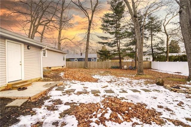 yard layered in snow with entry steps and fence