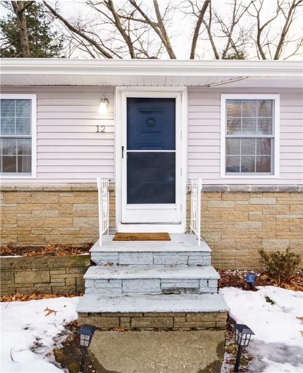 entrance to property with stone siding