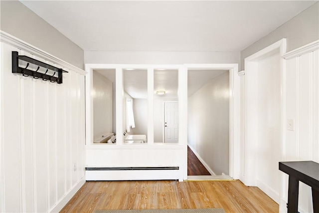 mudroom with baseboard heating and wood finished floors