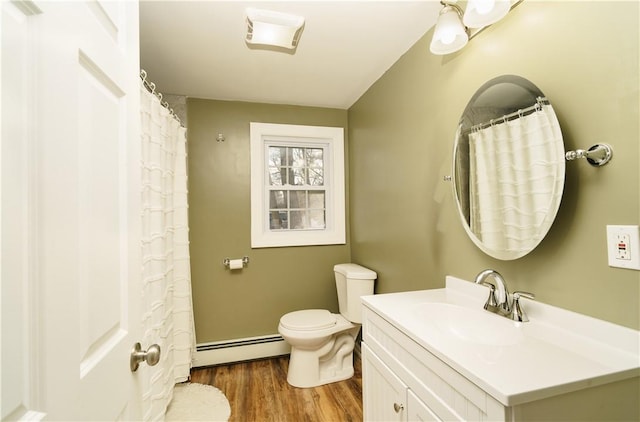 full bathroom with a baseboard radiator, vanity, toilet, and wood finished floors