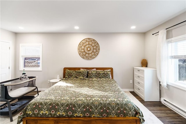 bedroom with baseboards, a baseboard heating unit, dark wood finished floors, and recessed lighting