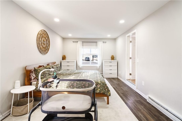 bedroom featuring baseboards, a baseboard heating unit, wood finished floors, and recessed lighting