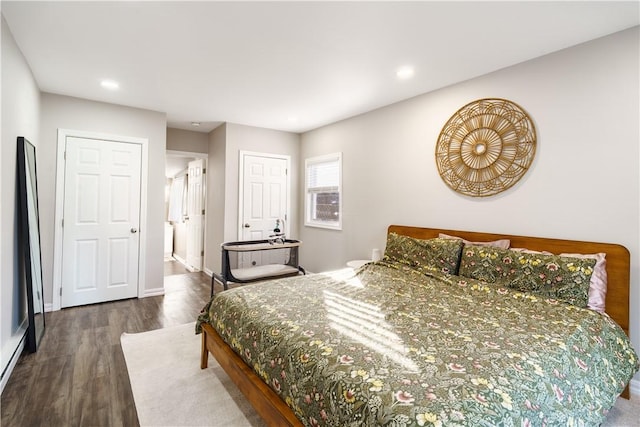 bedroom with dark wood-style flooring, recessed lighting, and baseboards