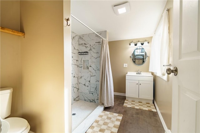 full bathroom with baseboards, a shower stall, toilet, and vanity