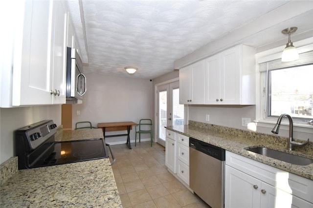 kitchen with stainless steel appliances, a wealth of natural light, white cabinetry, and a sink