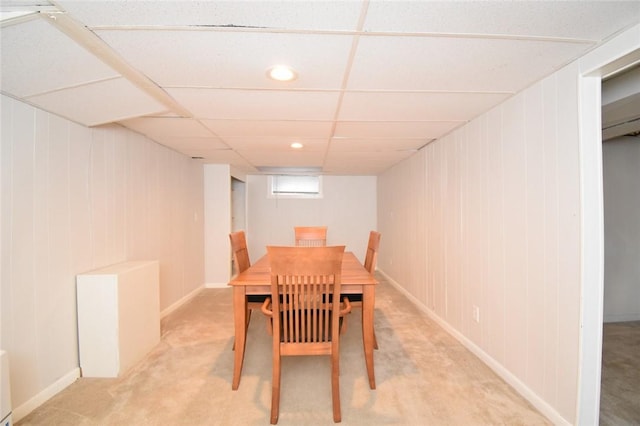 dining room with a drop ceiling and light colored carpet