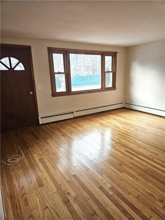 entryway featuring a baseboard radiator and wood-type flooring