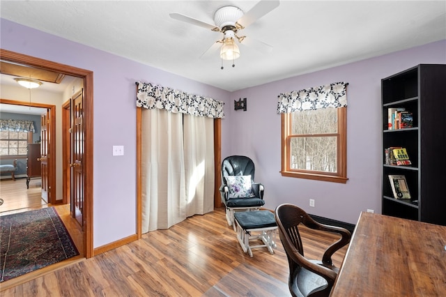 home office with ceiling fan, wood finished floors, attic access, and baseboards