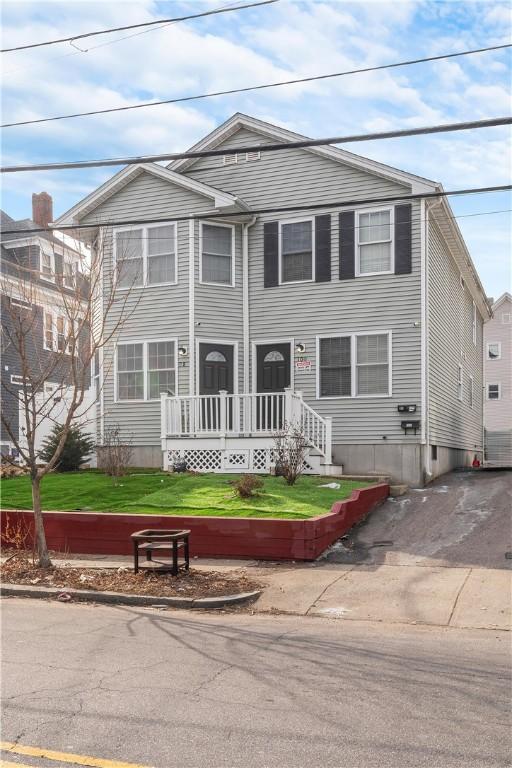 view of front of property with driveway and a front lawn