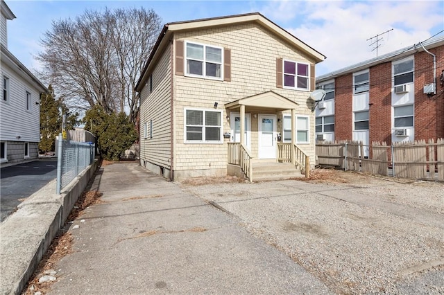 view of front of property featuring fence