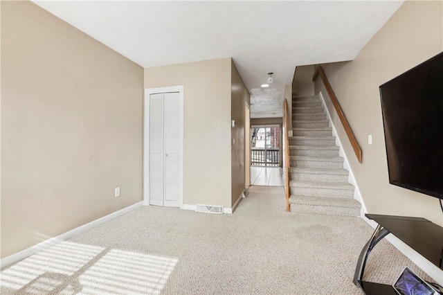 stairway with carpet, visible vents, and baseboards