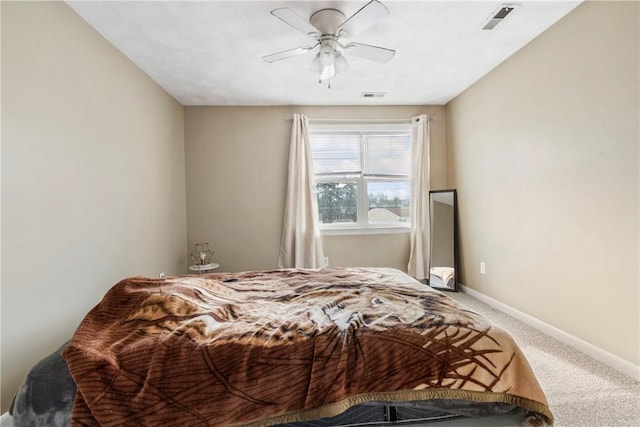 carpeted bedroom featuring a ceiling fan, visible vents, and baseboards