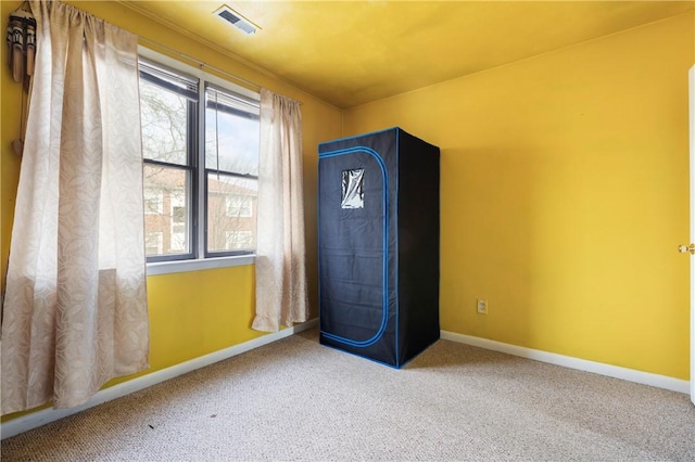 unfurnished bedroom featuring carpet floors, visible vents, and baseboards