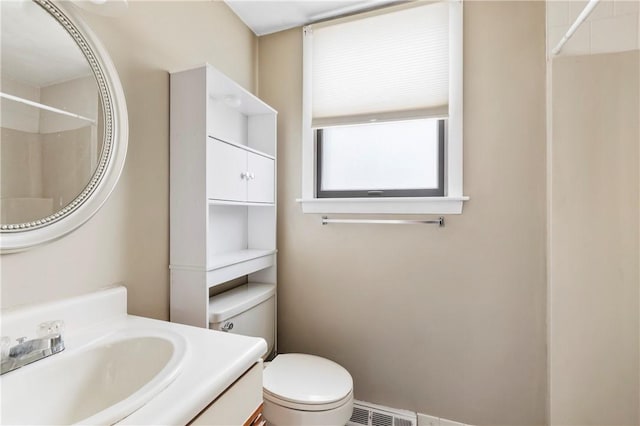 full bathroom with toilet, visible vents, walk in shower, and vanity