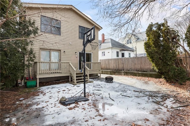 back of property featuring an outdoor fire pit, fence, and a wooden deck