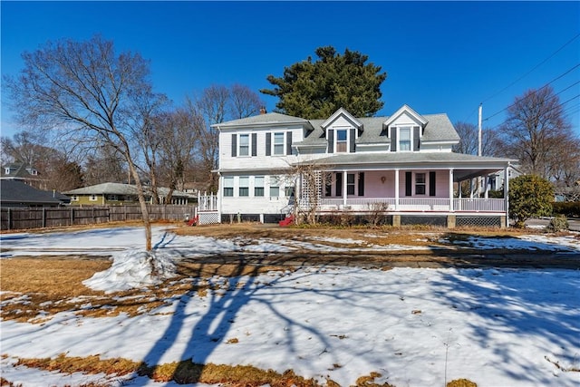 view of front of house with covered porch and fence