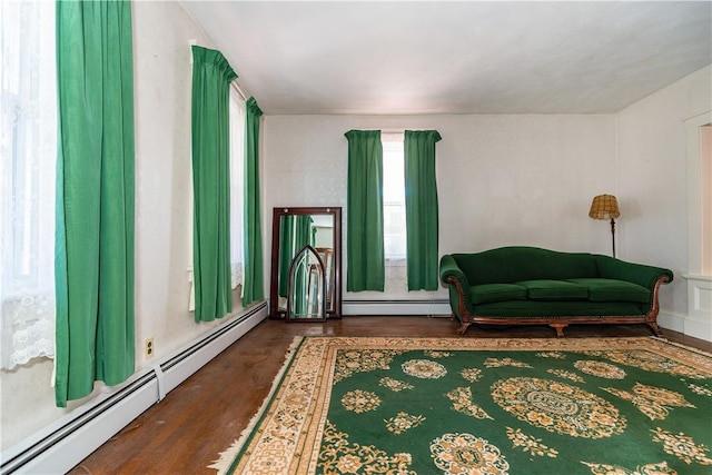 sitting room featuring baseboard heating and wood finished floors