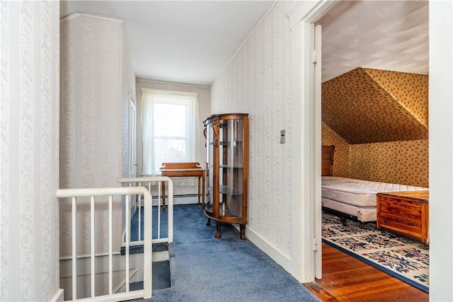 corridor featuring wallpapered walls, baseboards, and wood finished floors