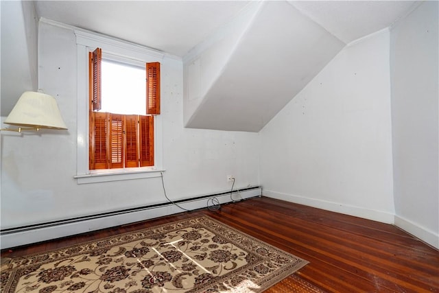 additional living space with vaulted ceiling, baseboard heating, wood finished floors, and baseboards