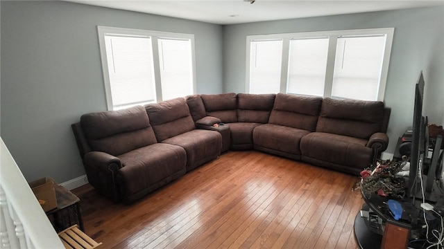 living area featuring light wood finished floors and baseboards