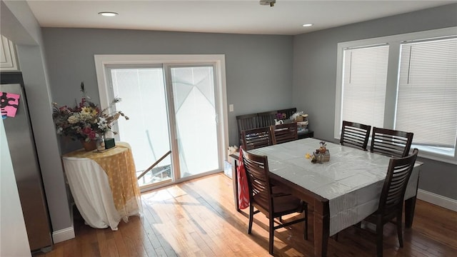 dining area featuring light wood-style flooring, baseboards, and recessed lighting