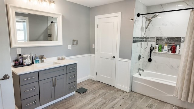 bathroom featuring shower / bath combo with shower curtain, vanity, and wood tiled floor