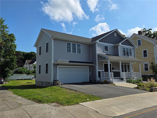 51 Spring St, Pawtucket, RI 02860 - view of front facade featuring a porch, an attached garage, driveway, and a front lawn