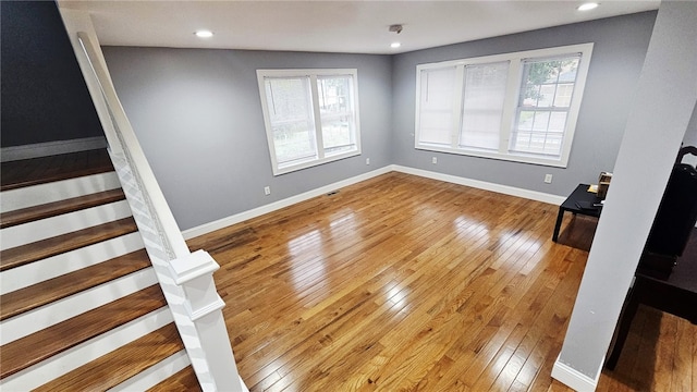 51 Spring St, Pawtucket, RI 02860 - unfurnished living room with light wood-type flooring, stairs, and recessed lighting