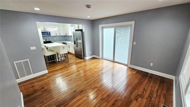 51 Spring St, Pawtucket, RI 02860 - unfurnished living room with hardwood / wood-style flooring and recessed lighting