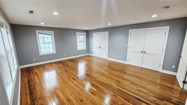 51 Spring St, Pawtucket, RI 02860 - unfurnished bedroom with multiple closets, light wood-style floors, and recessed lighting