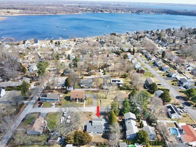 drone / aerial view featuring a residential view and a water view
