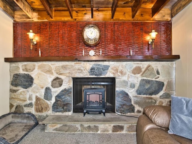 details featuring beam ceiling, a wood stove, and carpet