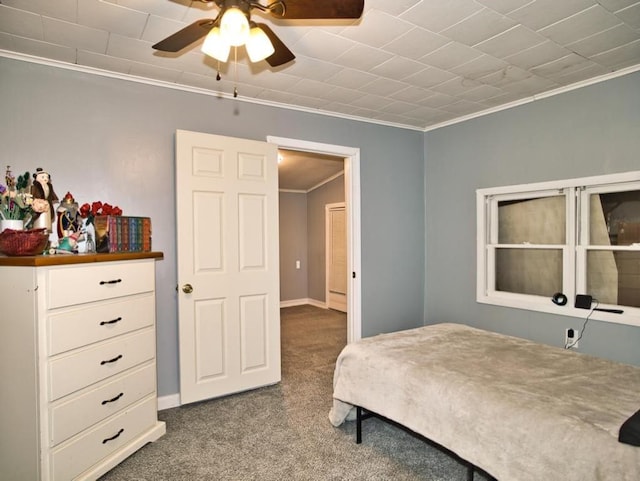 carpeted bedroom featuring a ceiling fan, crown molding, and baseboards