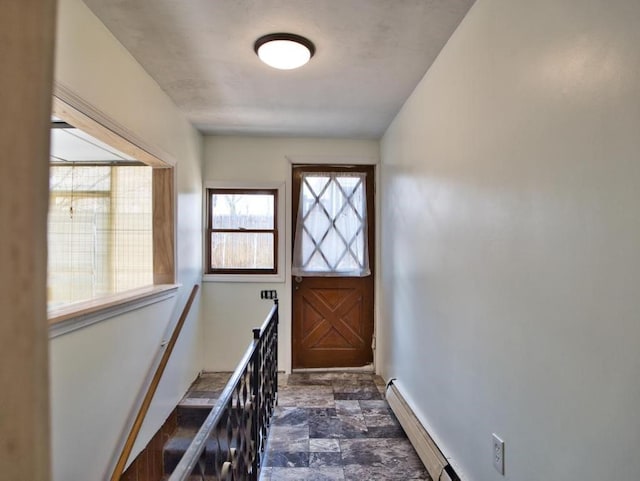 doorway with stone finish floor and baseboards