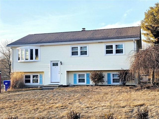 raised ranch featuring a front yard