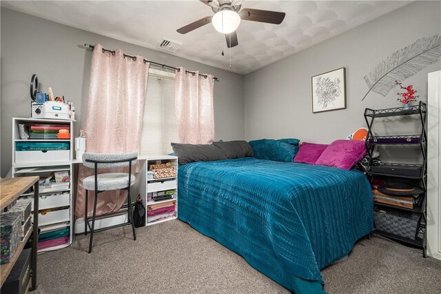 bedroom featuring ceiling fan, carpet floors, baseboard heating, and visible vents