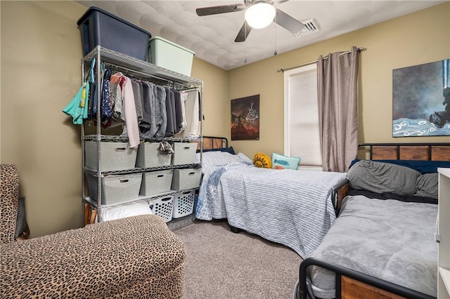 bedroom with a ceiling fan, carpet flooring, and visible vents