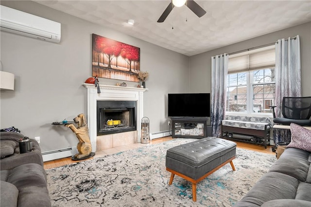 living room featuring ceiling fan, an AC wall unit, a baseboard radiator, and a fireplace with flush hearth