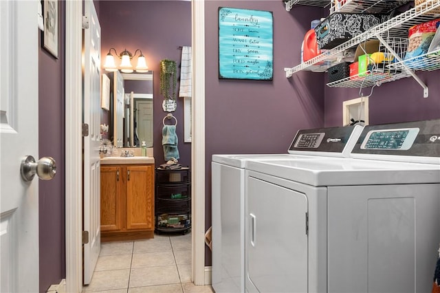 laundry room featuring laundry area, independent washer and dryer, and light tile patterned floors