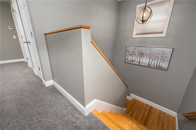 stairs with carpet floors and baseboards