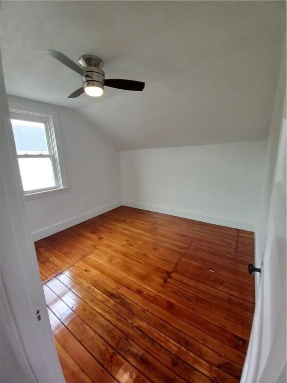 additional living space with lofted ceiling, baseboards, and hardwood / wood-style flooring